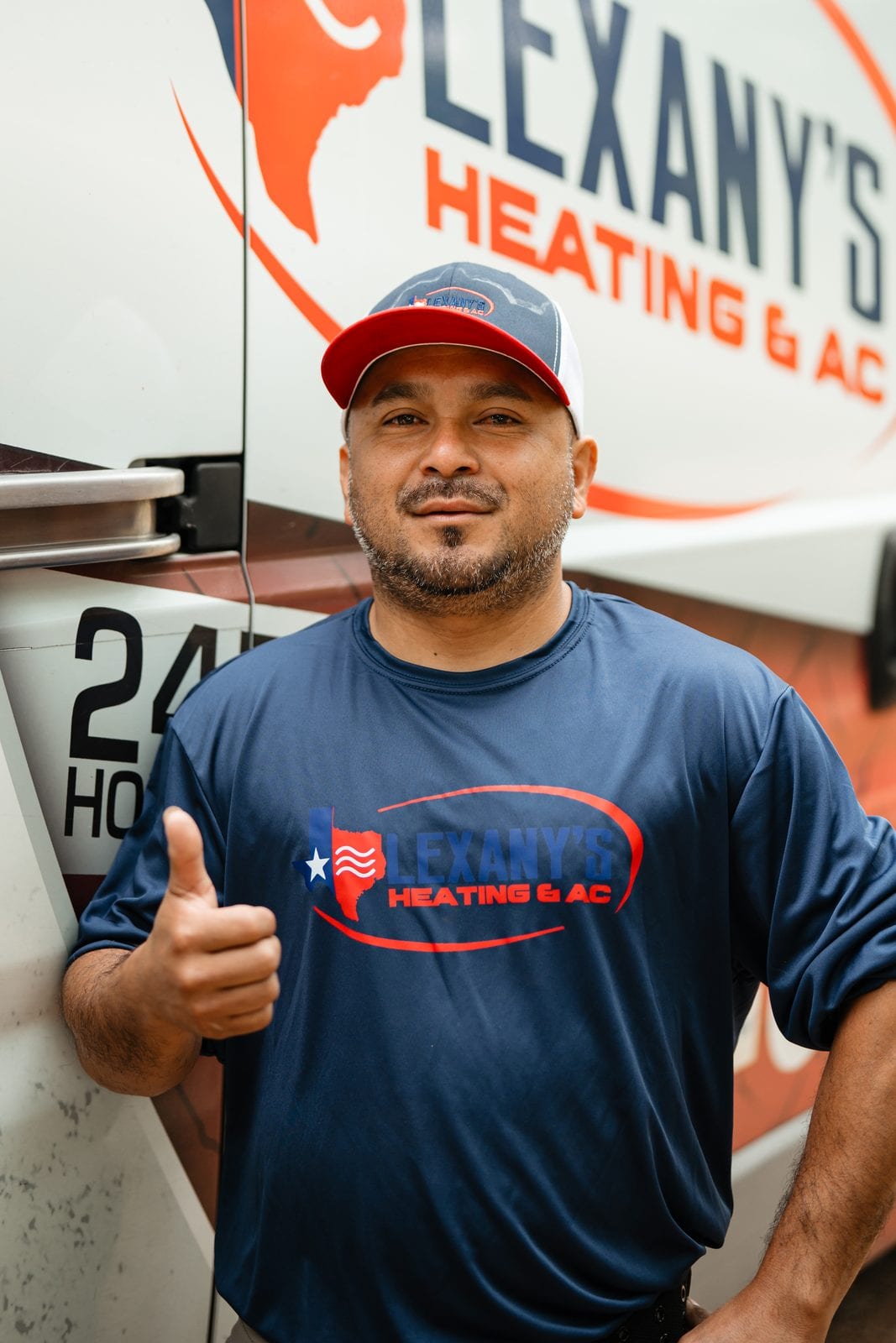 Gustavo, Lexany's Heating & AC owner, by the company service van in Forney, TX