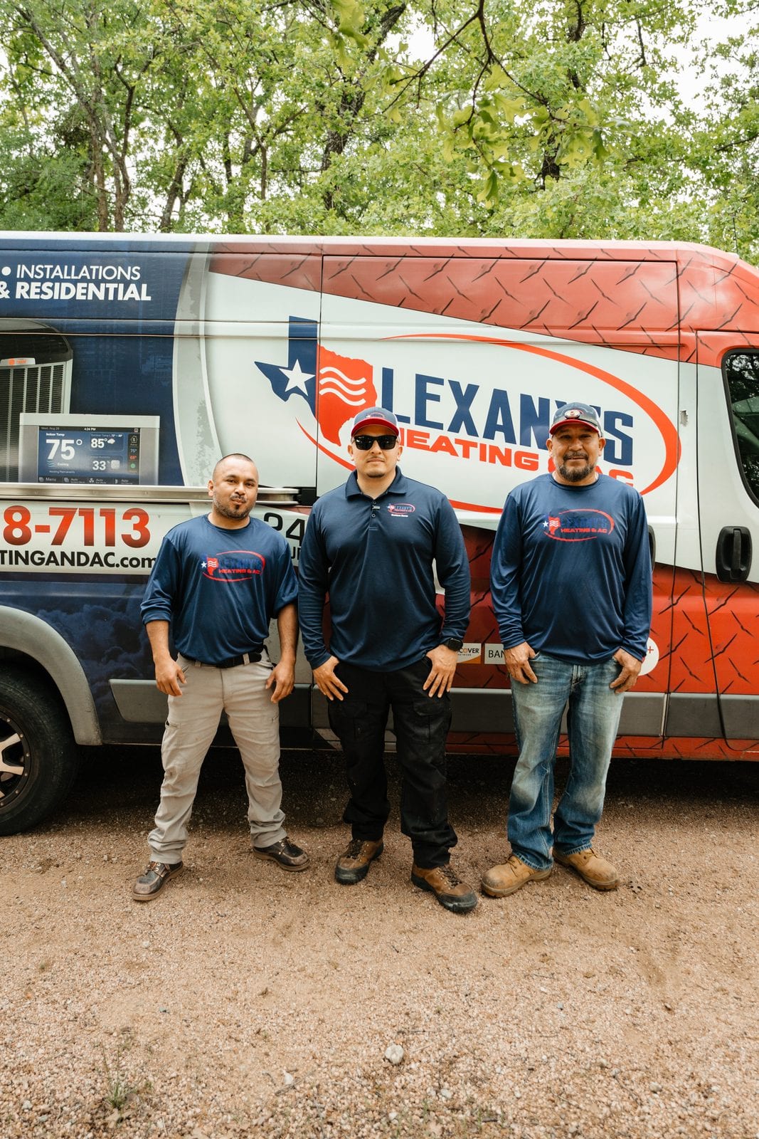The Lexany's Heating & AC team in uniform by the company service van